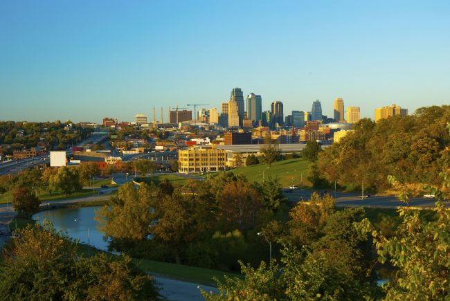 Kansas City skyline, trees, and a lake